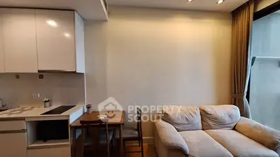 Cozy living room with modern kitchen and comfortable sofa in a bright apartment.