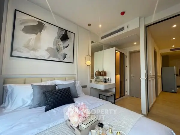 Modern bedroom with stylish decor and cozy ambiance in a luxury apartment.