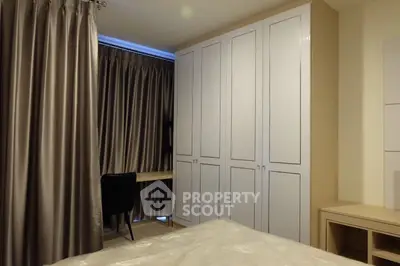 Modern bedroom with sleek wardrobe and elegant curtains