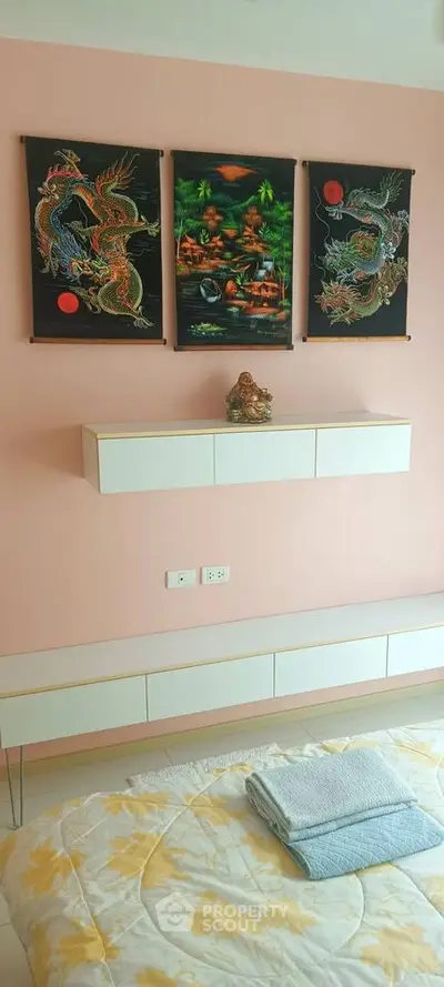 Cozy bedroom with artistic wall decor and modern shelving
