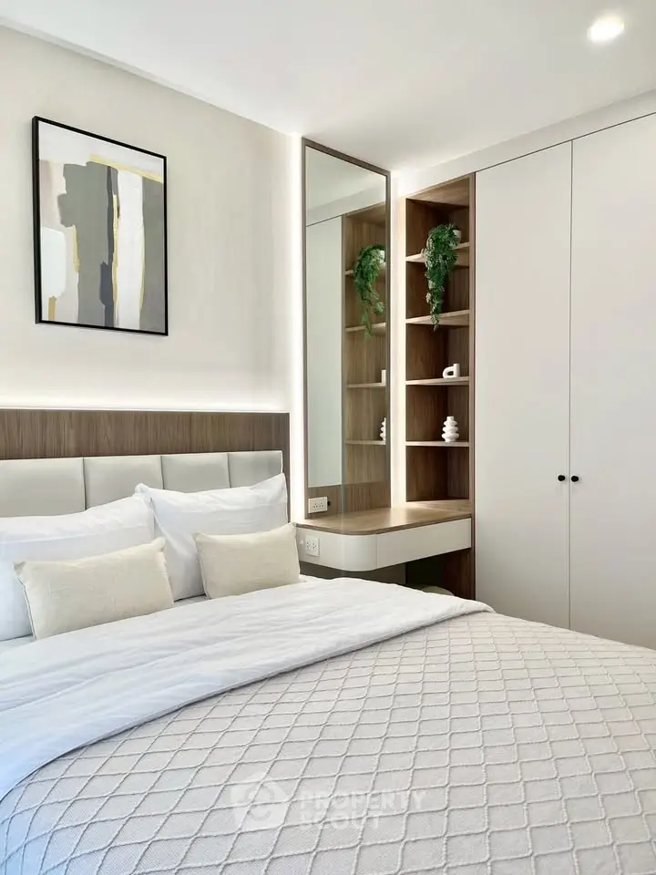 Modern bedroom with stylish decor and built-in storage, perfect for a cozy retreat.
