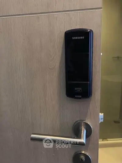 Modern digital door lock on wooden door in contemporary apartment.