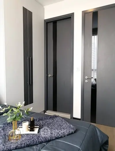 Modern bedroom with sleek gray doors and cozy bedding