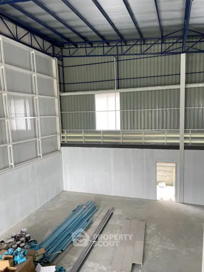 Spacious industrial warehouse interior with high ceilings and ample storage space.
