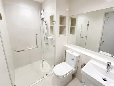 Modern bathroom with glass shower and sleek fixtures in a contemporary apartment.