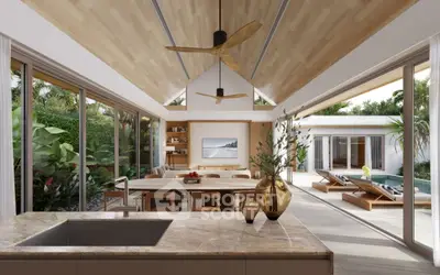 Luxurious open-plan kitchen and living area with poolside view and modern decor