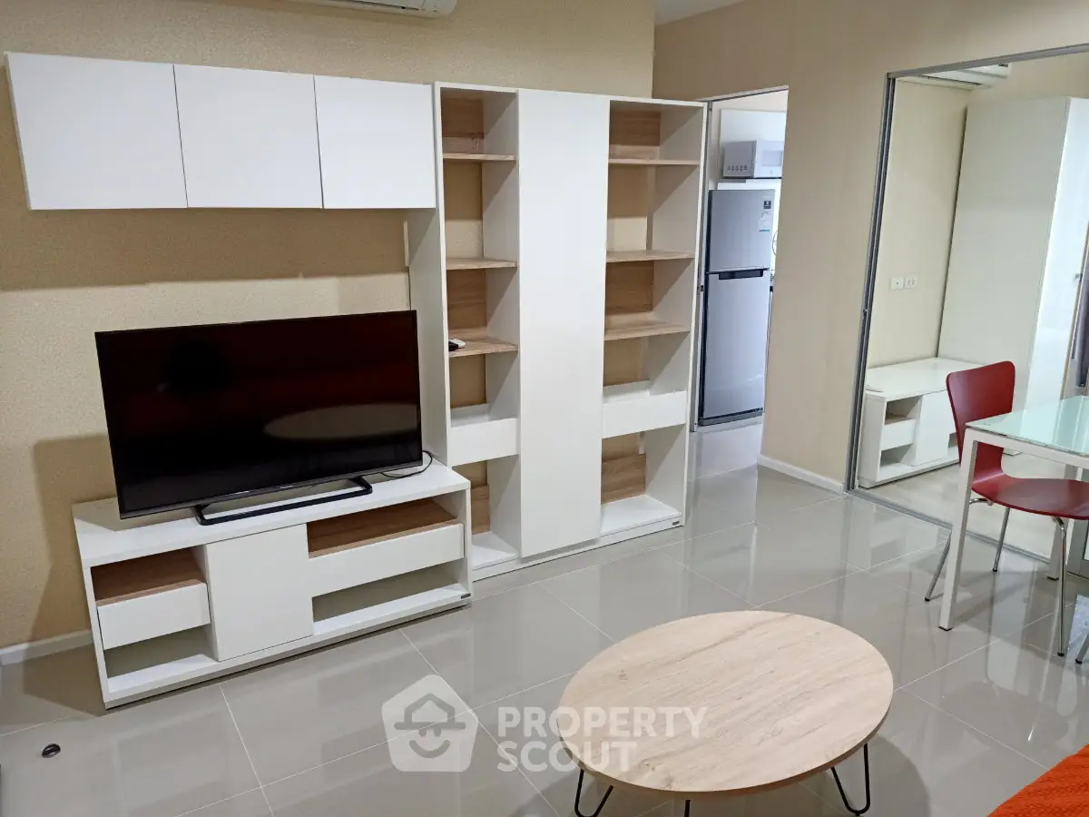 Modern living room with sleek furniture and open kitchen view, perfect for contemporary urban living.