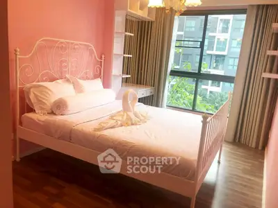 Charming bedroom with elegant bed and large window view in modern apartment.