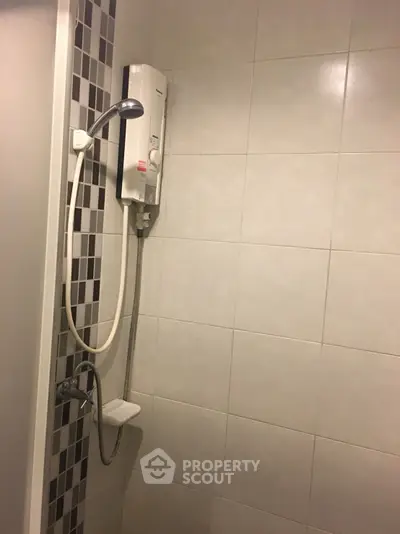 Modern bathroom with sleek shower and tiled walls, perfect for a contemporary home.