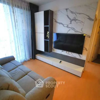 Modern living room with stylish TV setup and cozy sofa