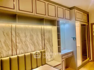 Luxurious bedroom with elegant built-in storage and modern lighting