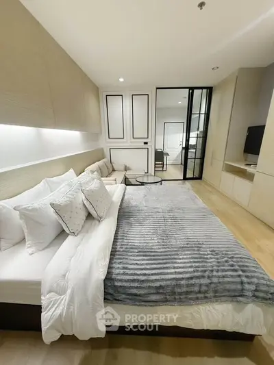 Luxurious modern bedroom with plush bedding and sleek design, perfect for comfort and style.