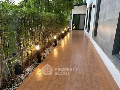 Elegant outdoor walkway with modern lighting and lush greenery