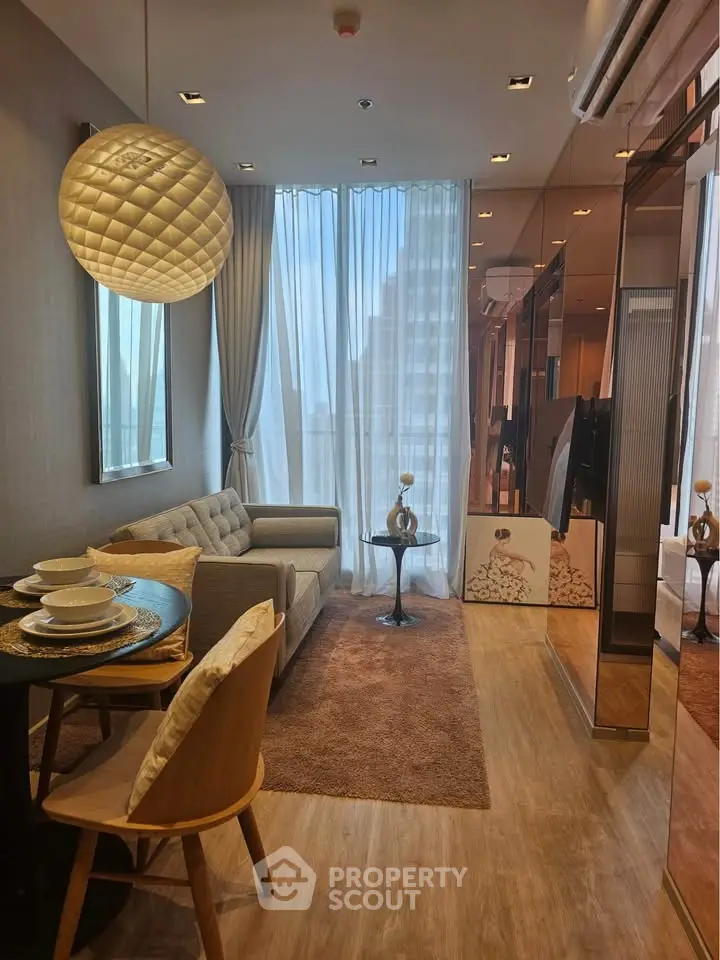 Modern living room with elegant decor and large windows in a luxury apartment.