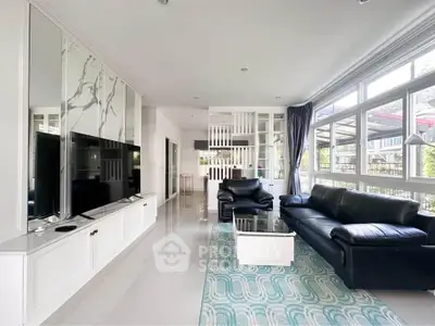 Spacious modern living room with large windows and elegant decor