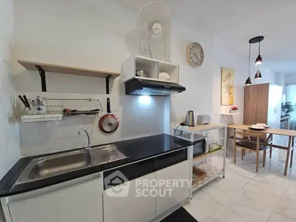 Modern kitchen with sleek black countertop and open shelving