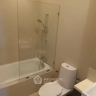 Modern bathroom with glass shower and bathtub combination