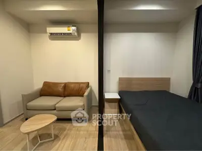 Modern studio apartment with cozy living area and comfortable bed