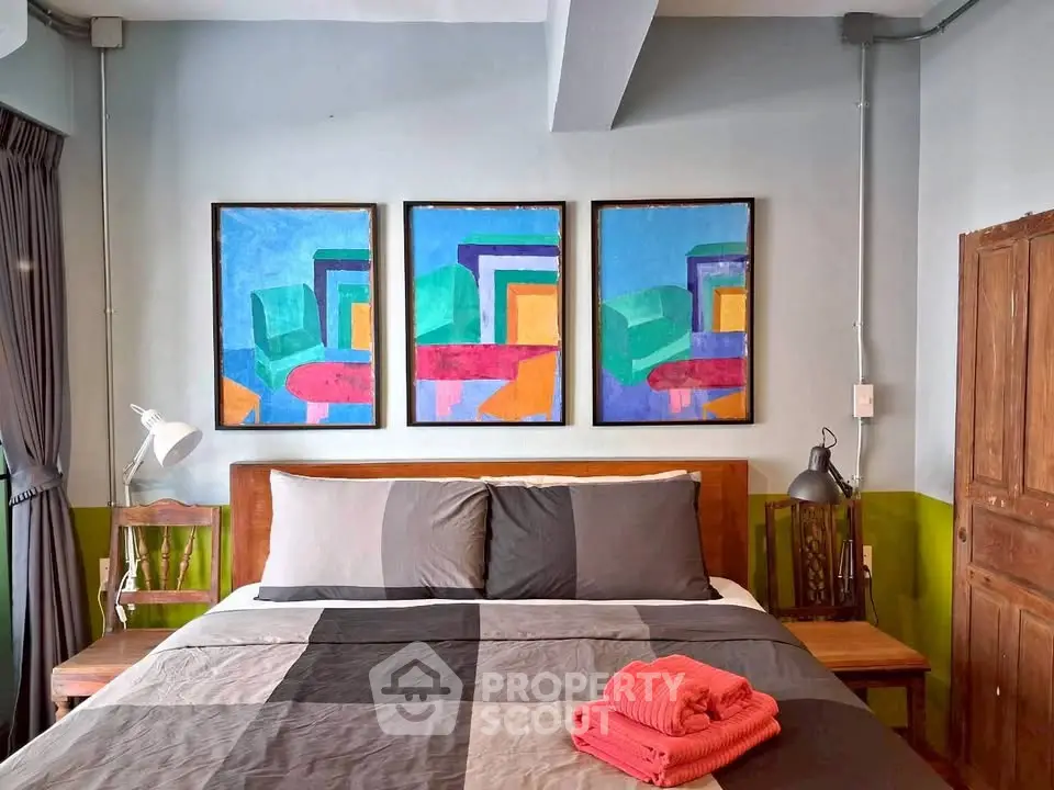 Stylish bedroom with modern art and cozy bedding in a contemporary home.