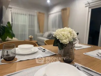 Elegant dining setup with floral centerpiece in modern living room