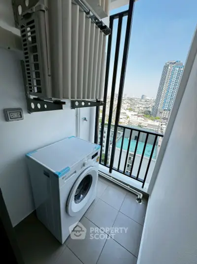 Modern high-rise balcony with washing machine and city view