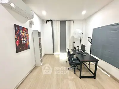 Modern study room with sleek desk, dual monitors, and stylish decor, perfect for productivity and creativity.
