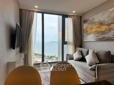 Luxurious living room with stunning ocean view, modern decor, and floor-to-ceiling windows in a high-rise apartment.