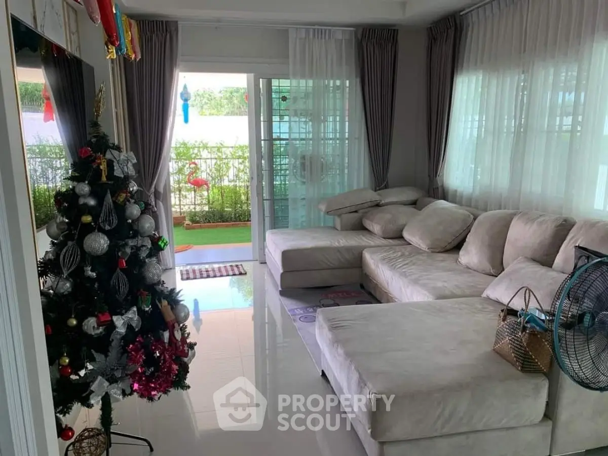 Spacious living room with cozy sectional sofa and festive Christmas decor