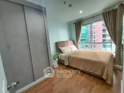 Cozy bedroom with large window and modern decor in urban apartment