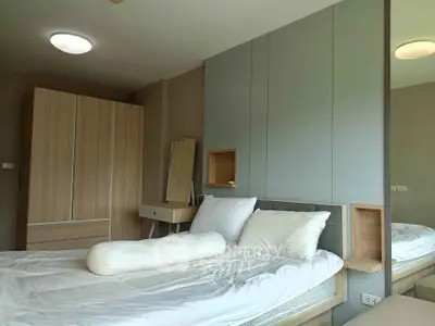 Modern bedroom with stylish wooden furniture and cozy bedding