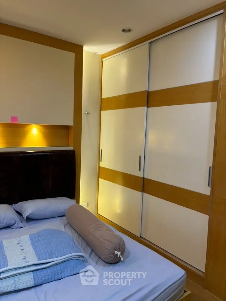 Cozy bedroom with built-in wardrobe and ambient lighting