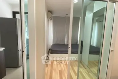 Modern apartment with sleek sliding glass doors and cozy bedroom.