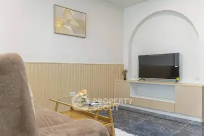 Modern living room with stylish decor and flat-screen TV