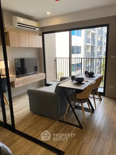 Modern living room with dining area and balcony view in stylish apartment
