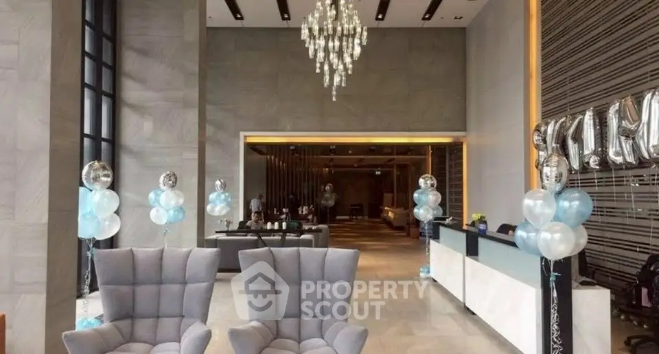Luxurious hotel lobby with elegant chandelier and modern seating area