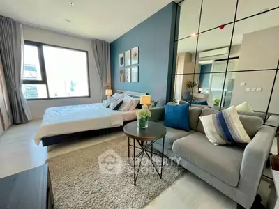 Modern studio apartment with stylish decor and large window view