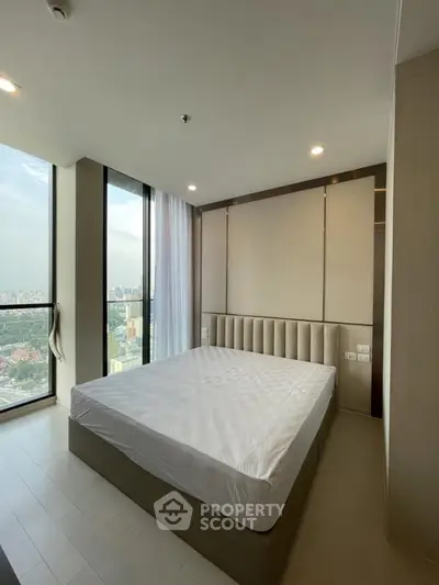 Luxurious bedroom with panoramic city view and elegant design