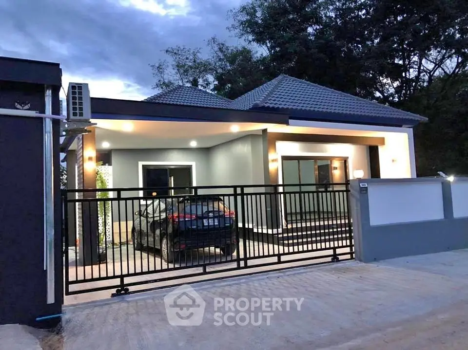 Modern single-story house with gated driveway and sleek exterior design