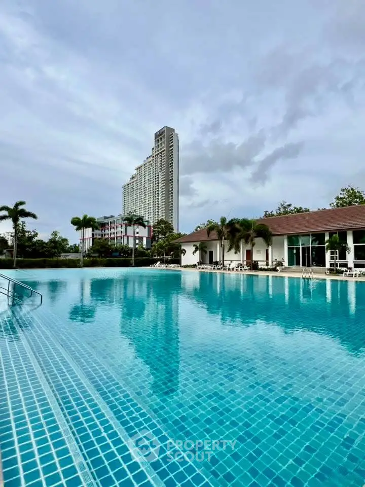 Luxurious residential complex with stunning pool and modern high-rise building.