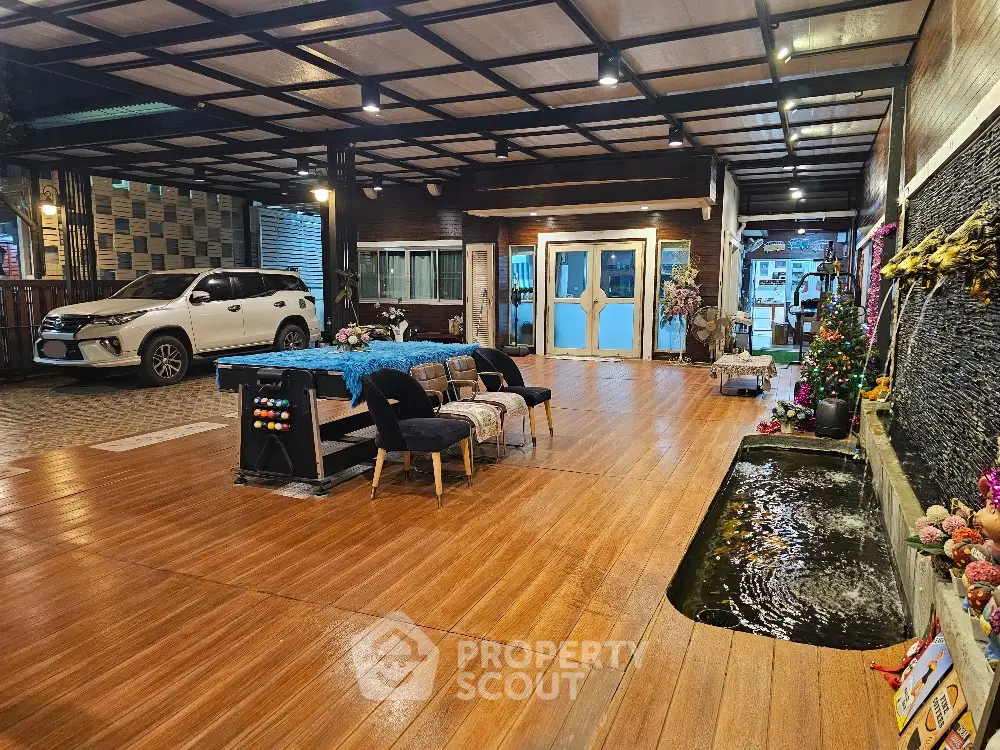 Spacious covered parking area with wooden flooring and decorative elements