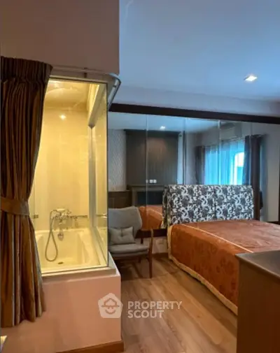 Luxurious bedroom with elegant decor and glass-enclosed bathtub, perfect for relaxation and comfort.