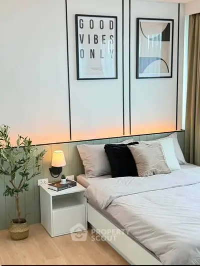 Modern bedroom with stylish decor and cozy ambiance, featuring a comfortable bed and elegant wall art.
