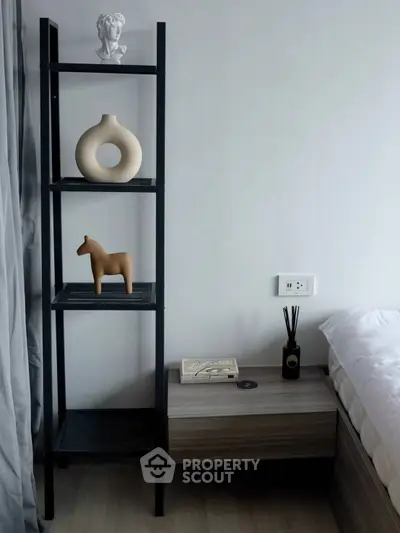 Modern bedroom with stylish decor and sleek shelving unit