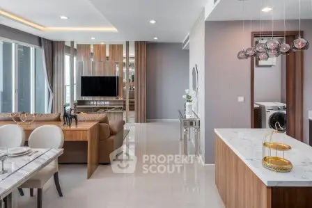 Luxurious modern living room with open kitchen and elegant decor in high-rise apartment.