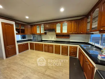 Spacious kitchen with wooden cabinets and modern appliances