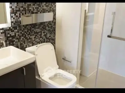 Modern bathroom with sleek design and mosaic tile accent wall