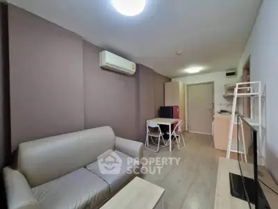 Cozy living room with modern furniture and air conditioning, perfect for relaxation.