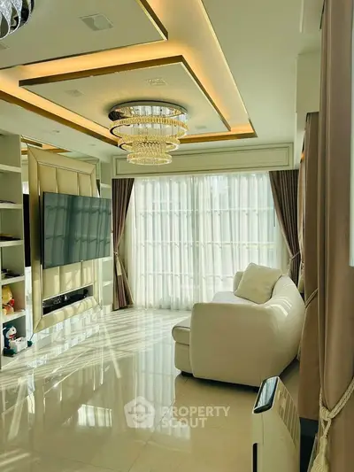 Luxurious living room with elegant chandelier and floor-to-ceiling windows
