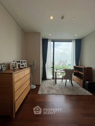 Elegant study room with city view, wooden furniture, and large window for natural light.