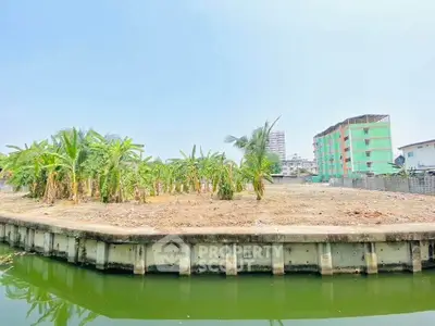 Prime real estate land with canal view and lush greenery, ideal for development opportunities.